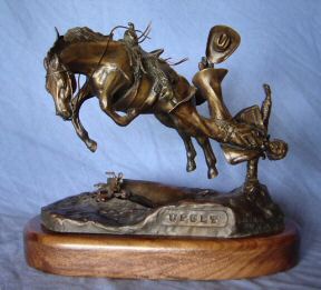 bronze sculpture named  "UPSET" of a bucking horse and rider